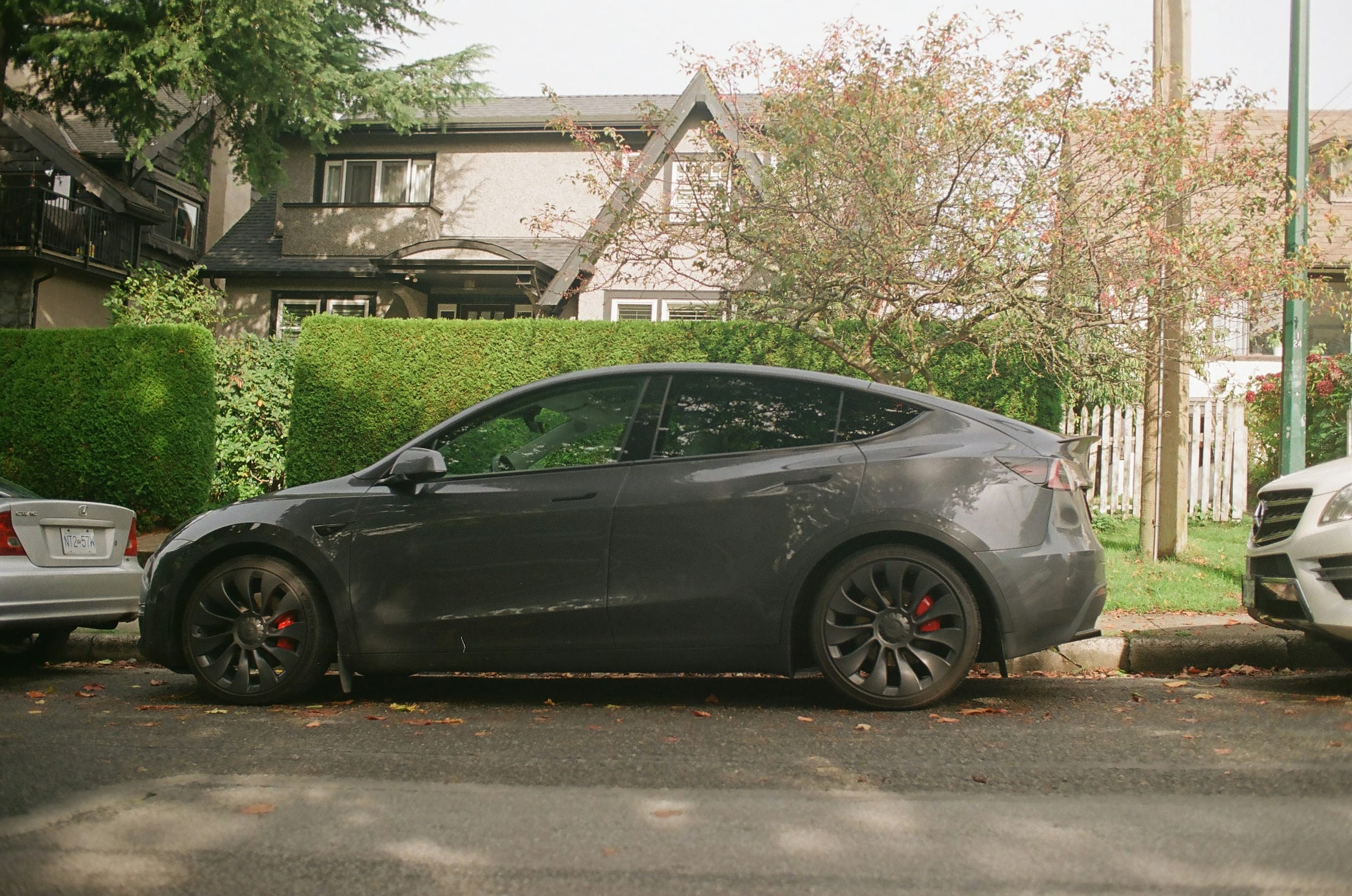 Grey Tesla Model Y parked on a residential street